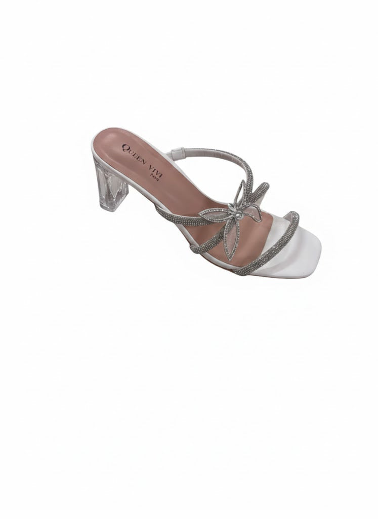 Mules blanches à talon transparent brides strass et détail nœud bijou