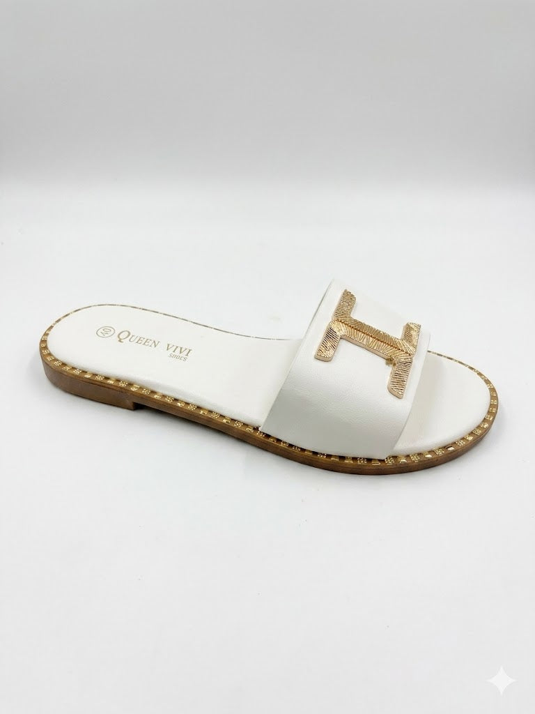 Mule plate à bride large avec logo H doré texturé et semelle bordée de clous dorés