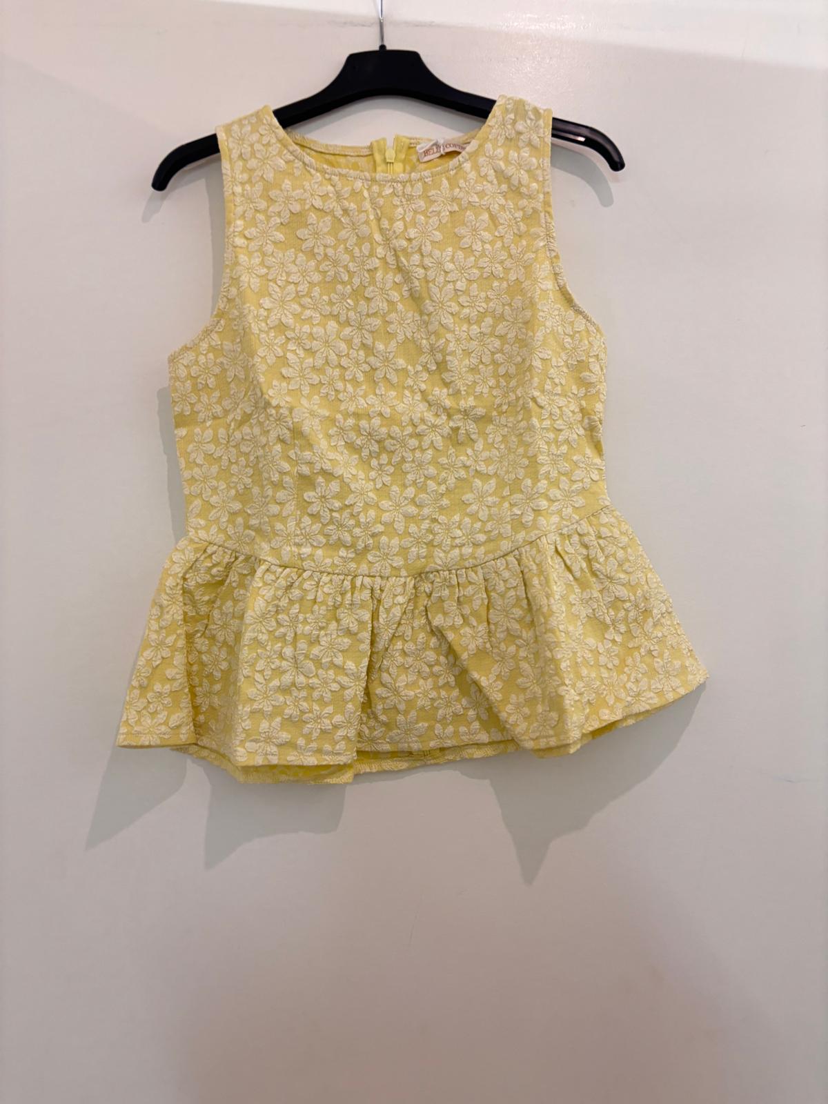 Top peplum sans manches en broderie anglaise florale col rond et fermeture dos