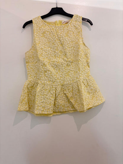 Top peplum sans manches en broderie anglaise florale col rond et fermeture dos