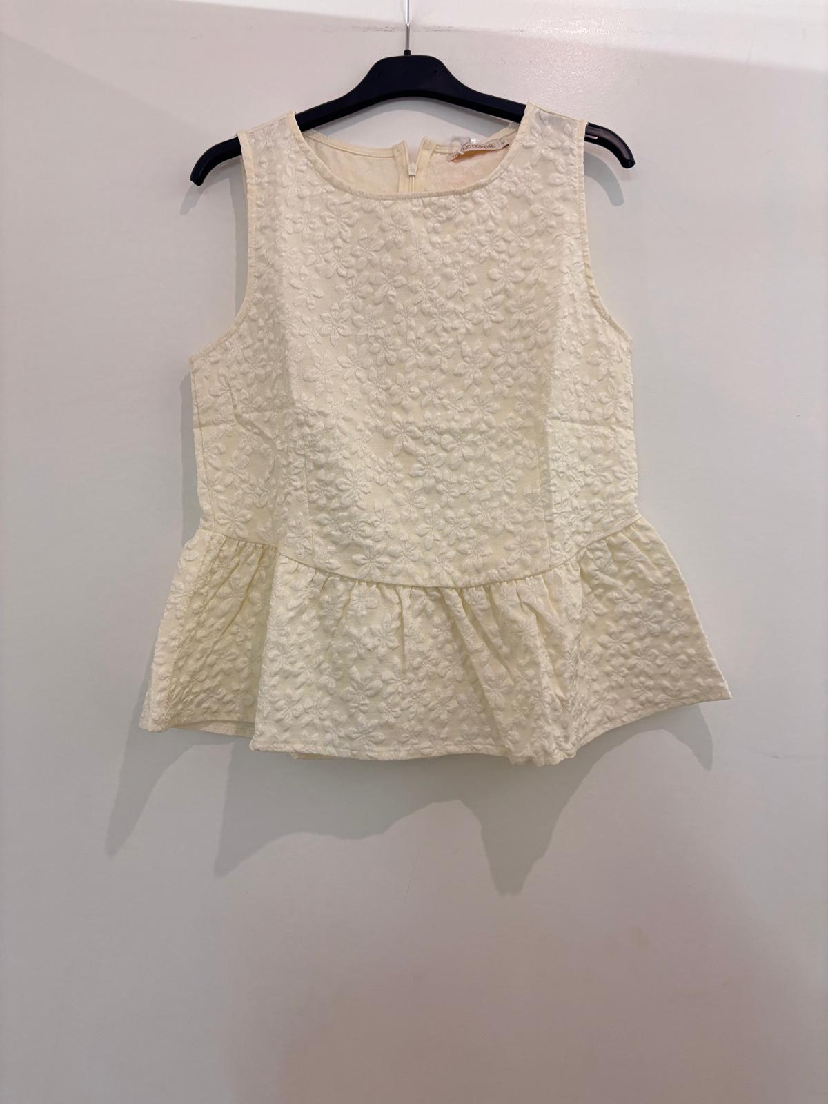 Top peplum sans manches en broderie anglaise florale col rond et fermeture dos